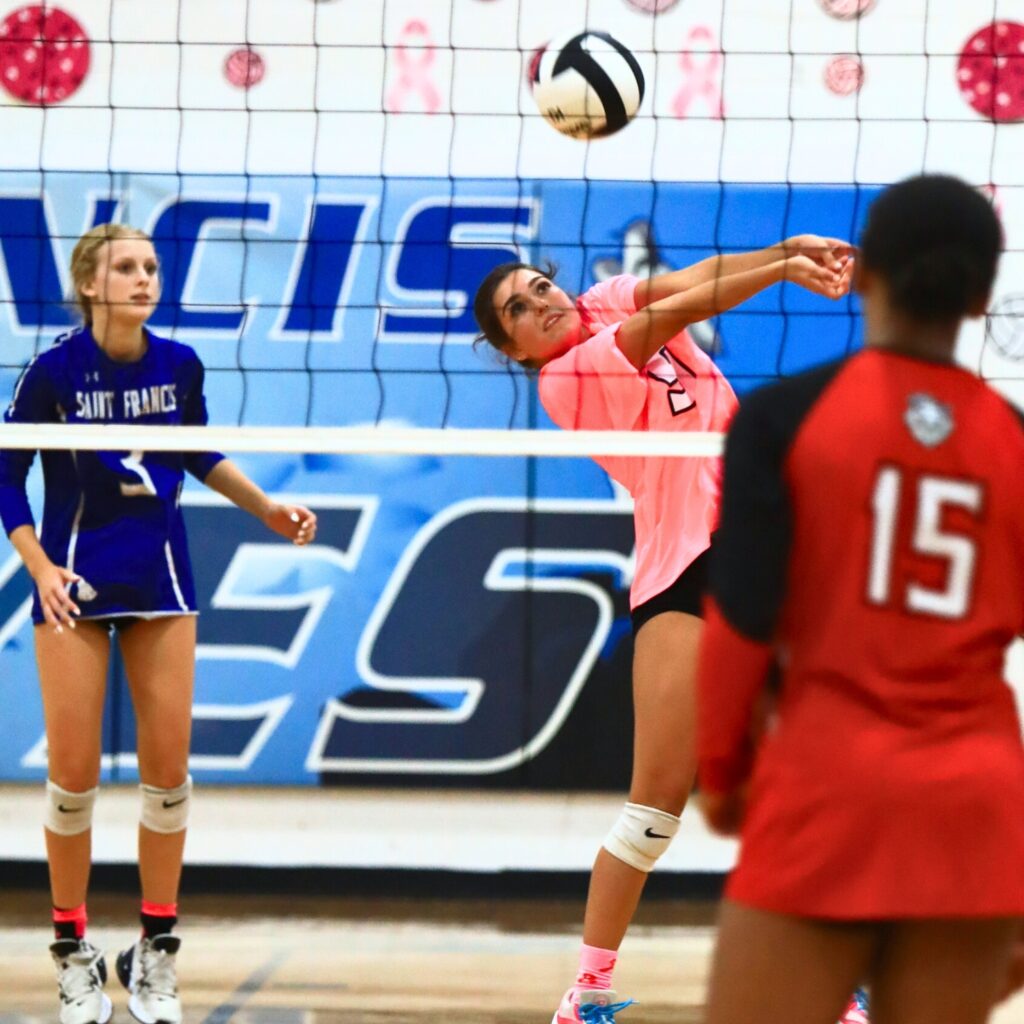Saint Francis Catholic's Gianna Morali (9) with a dig against The Rock. Photo by C.J. Gish