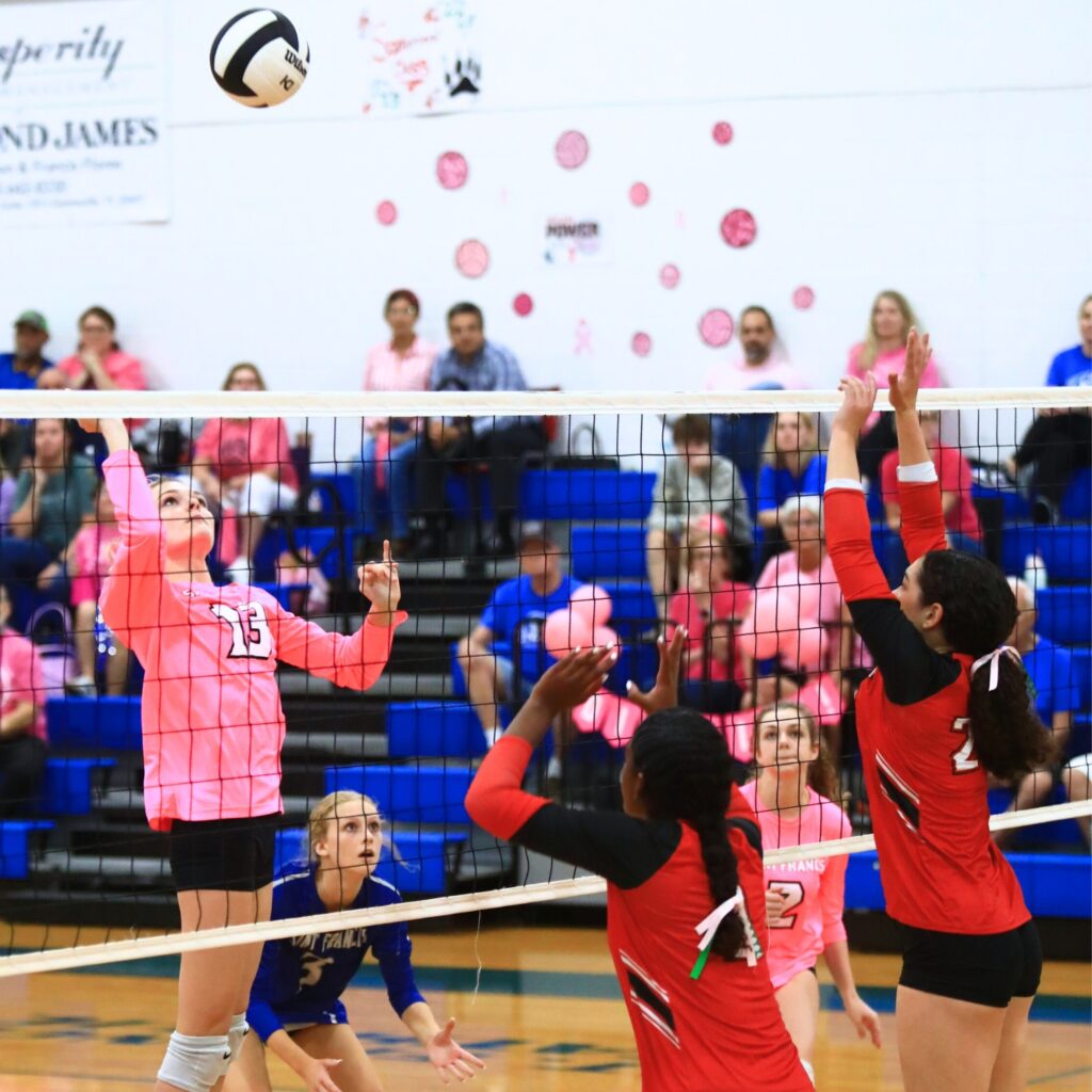 Saint Francis Catholic's Katelyn Elder (13) lines up for a hit against The Rock's Ari Howard (9) and Marlin Tyson (25). Photo by C.J. Gish