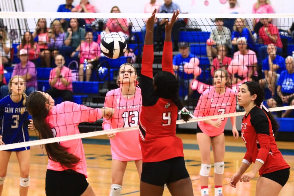 Saint Francis Catholic's Naomi Magary (12) with a dig at the net against The Rock. Photo by C.J. Gish