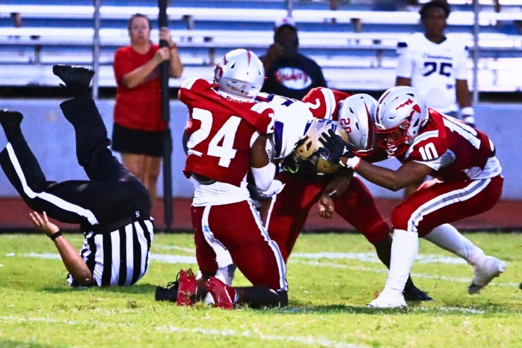 Santa Fe defenders take down a University Christian (Jacksonville) receiver and a referee. Photo by C.J. Gish