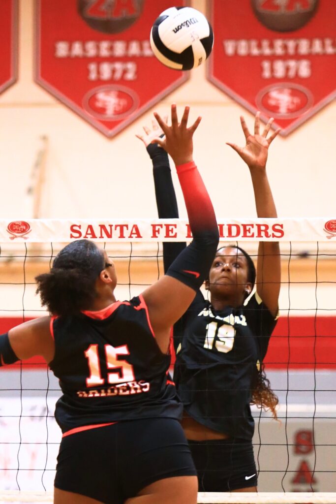 Santa Fe's Ajha Graddy (15) and Buchholz's Aaliyah Ray (19) battle at the net. Photo by C.J. Gish (1)