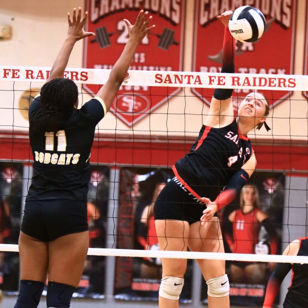 Santa Fe's Brooke Findley (4) with a hit against Buchholz's Demmi Strappy (11). Photo by C.J. Gish