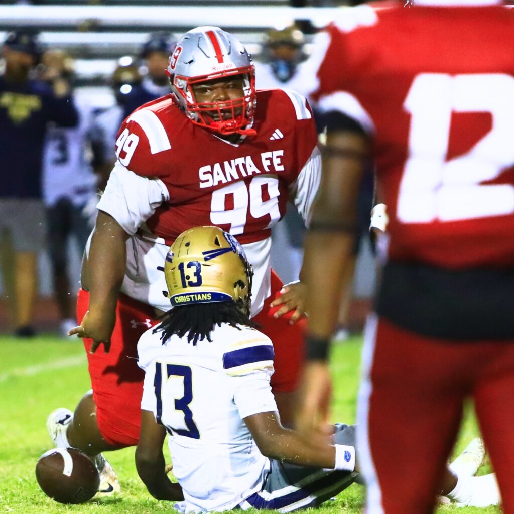 Santa Fe's Damarcus Mells (99) with a tackle against University Christian (Jacksonville). Photo by C.J. Gish