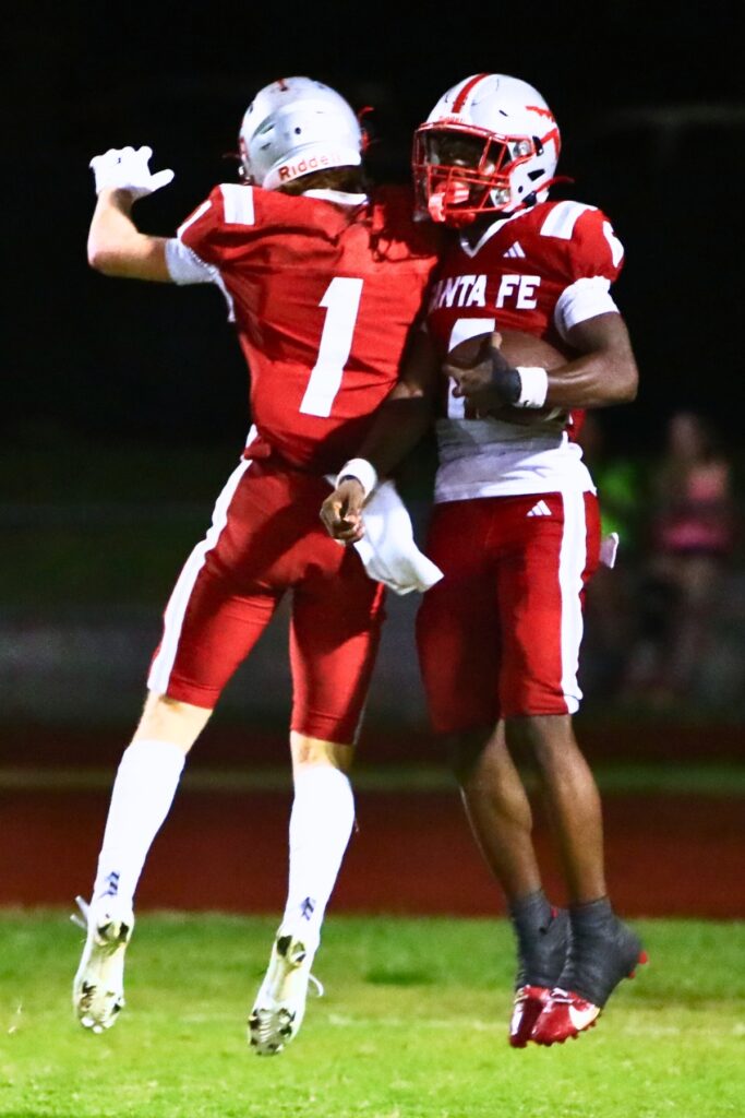 Santa Fe's Dantre Little (6) celebrates with Tyler Gentry (1) after scoring a second-quarter touchdown against University Christian (Jacksonville). Photo by C.J Gish