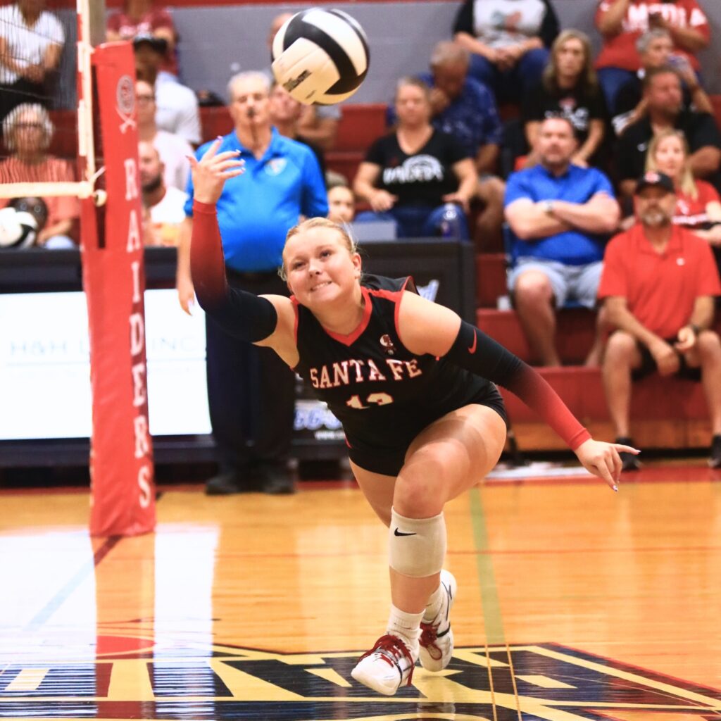 Santa Fe's Gracyn Marshall (13) keeps the ball alive against Buchholz. Photo by C.J. Gish