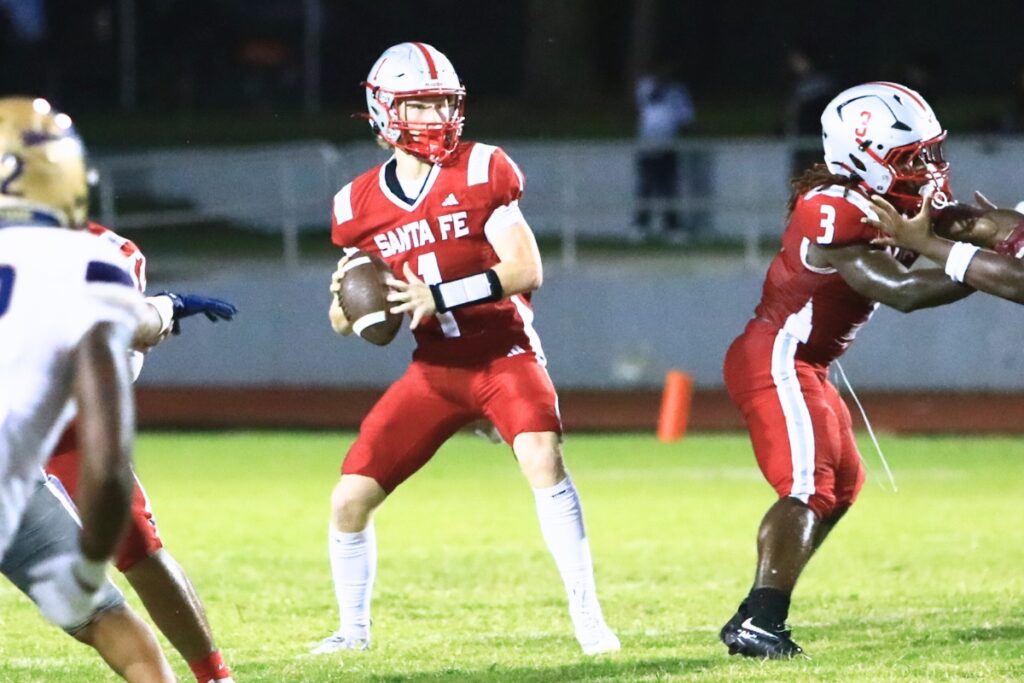 Santa Fe's Tyler Gentry (1) looks downfield to pass against University Christian (Jacksonville). Photo by C.J. Gish
