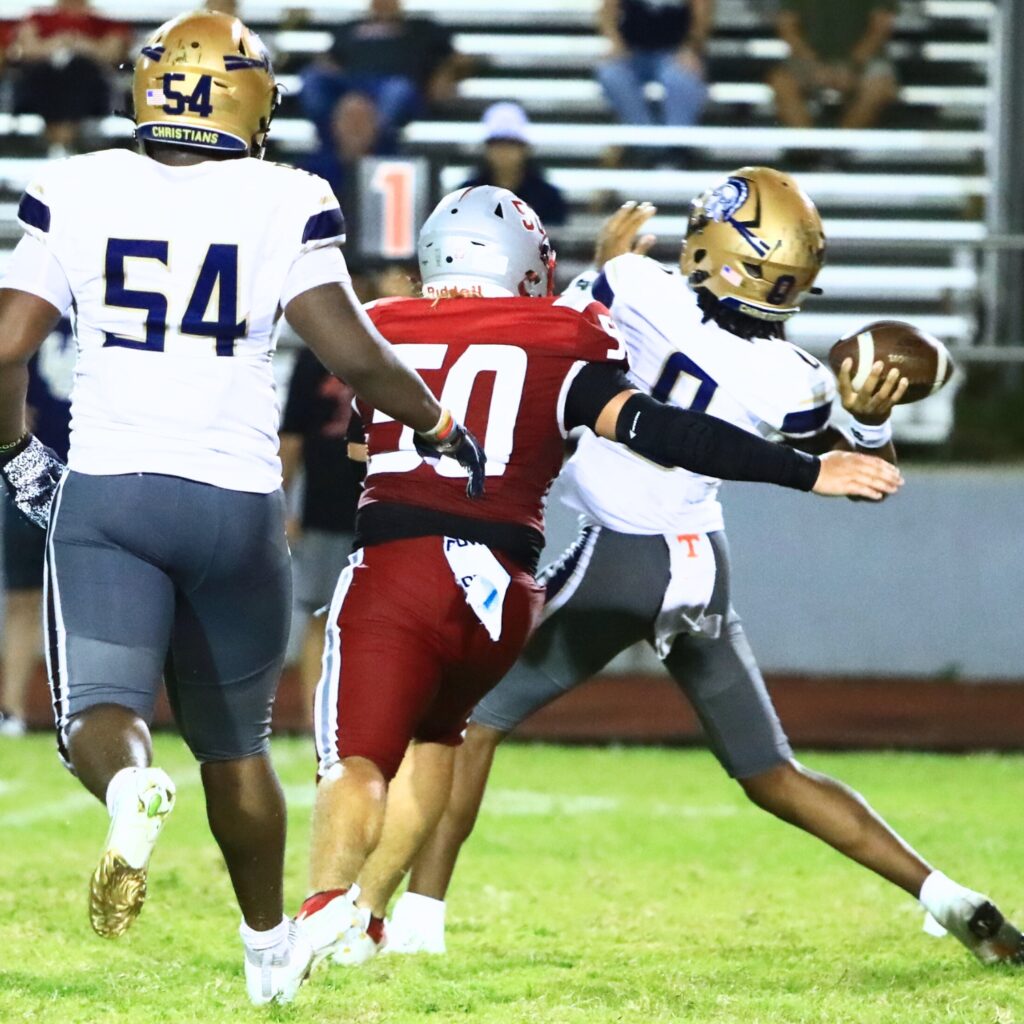 Santa Fe's Zachary Perez (50) pressures the University Christian (Jacksonville) quarterback. Photo by C.J. Gish