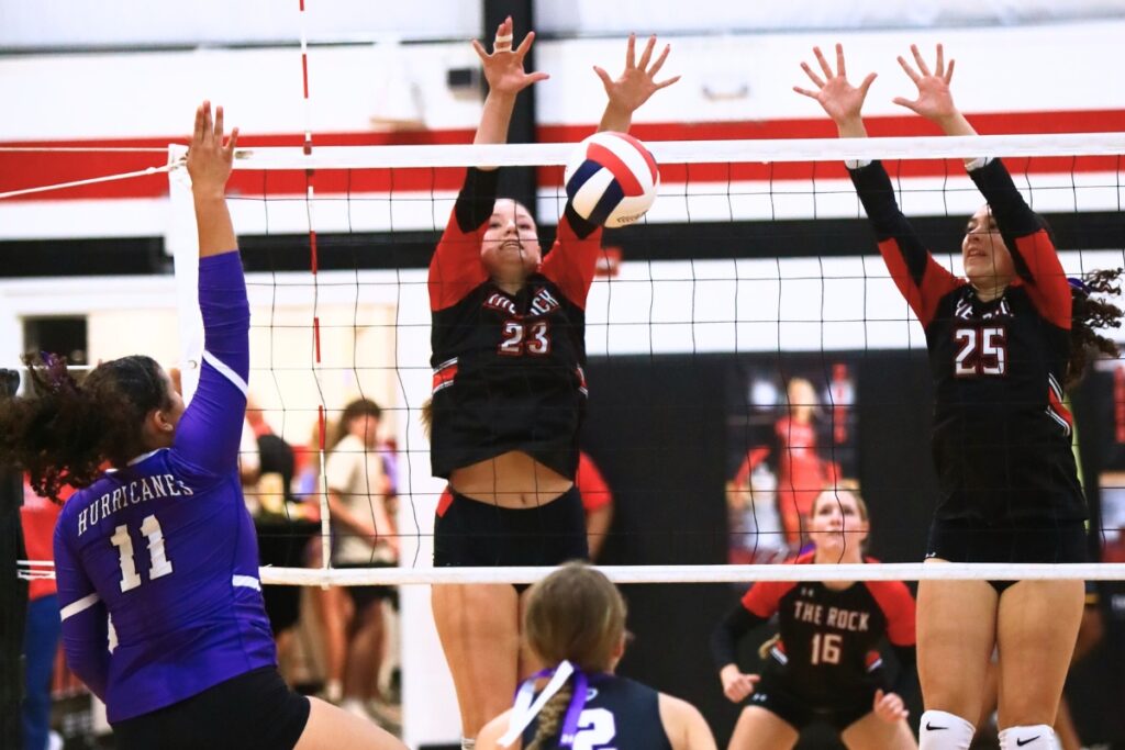 The Rock's Alexis Rhoden (23) and Marlin Tyson (25) go for a block against Gainesville's Kenzie Carter-Mitchell (11). Photo by C.J. Gish