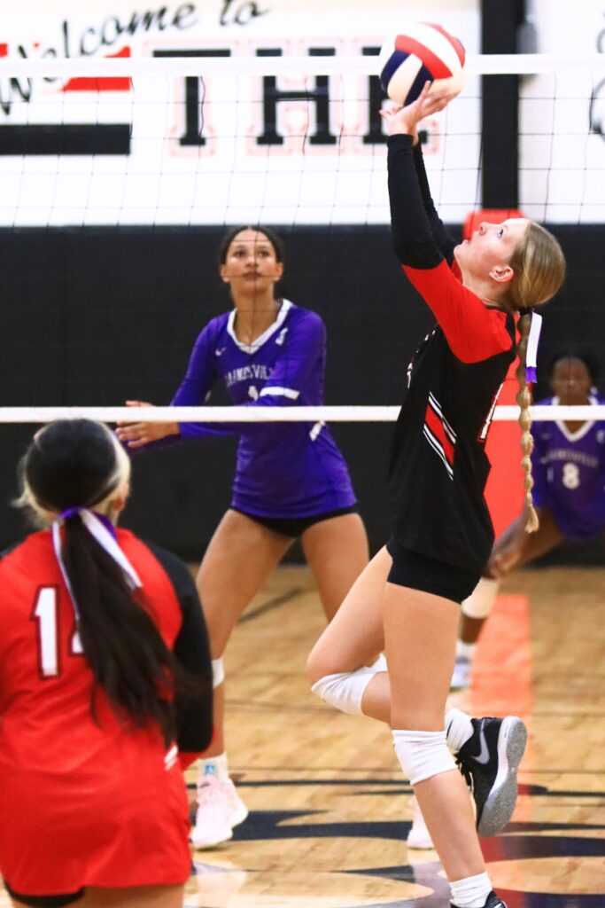 The Rock's Callie Kieszeck (16) with a set against Gainesville. Photo by C.J. Gish
