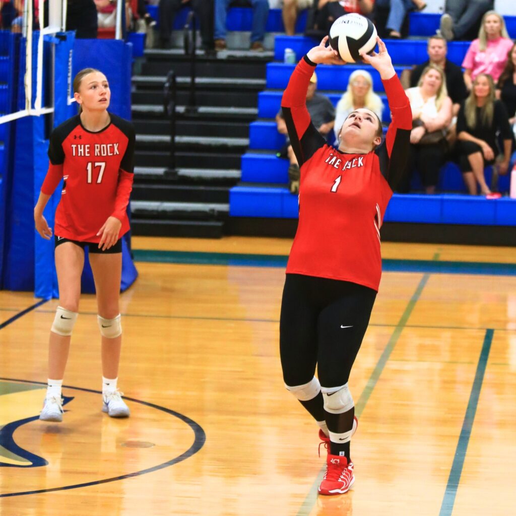 The Rock's Kylie Rhoden (1) with a set against Saint Francis Catholic Academy. Photo by C.J. Gish