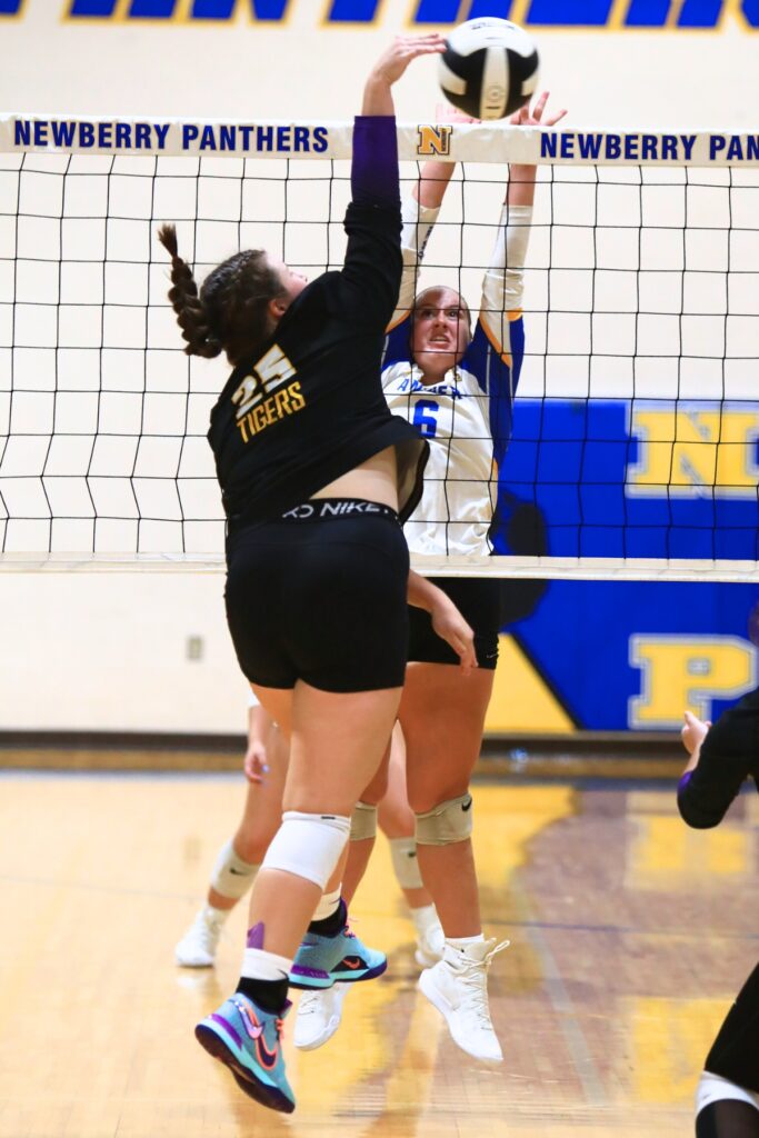 Union County's Indi Knox (25) and Newberry's Kinsley Harvey (6) battle at the net. Photo by C.J. Gish