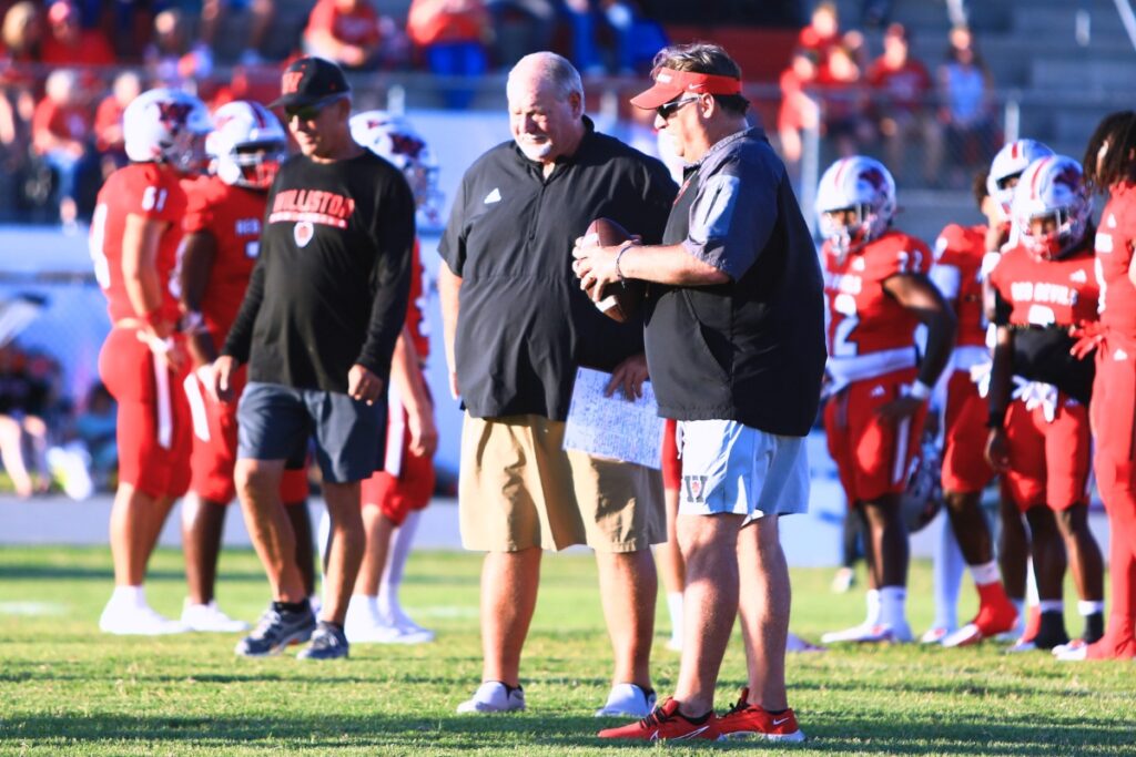 Williston head coach Robby Pruitt (center in khaki shorts) has led the Red Devils to 32 wins over the past three-plus seasons. Photo by C.J. Gish