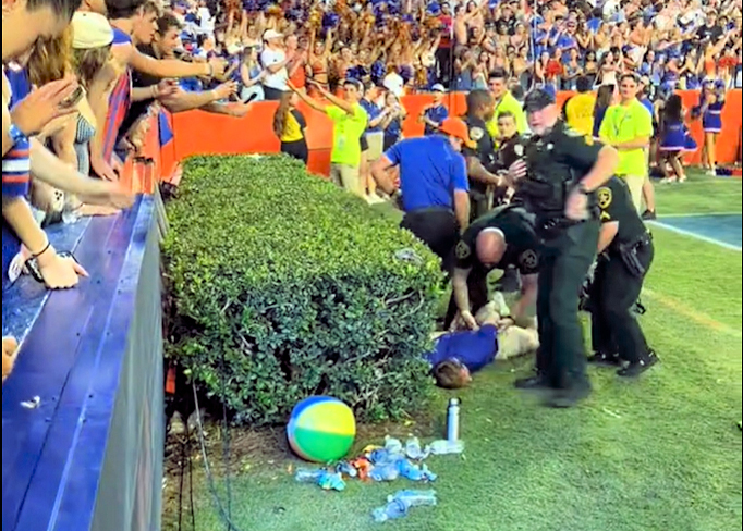 John Paul Schmidt, 27, of Greensboro, N.C., is taken in to custody by Alachua County Sheriff’s deputies following Florida’s 29-21 win over Texas on Saturday, Oct. 4, 2025. 