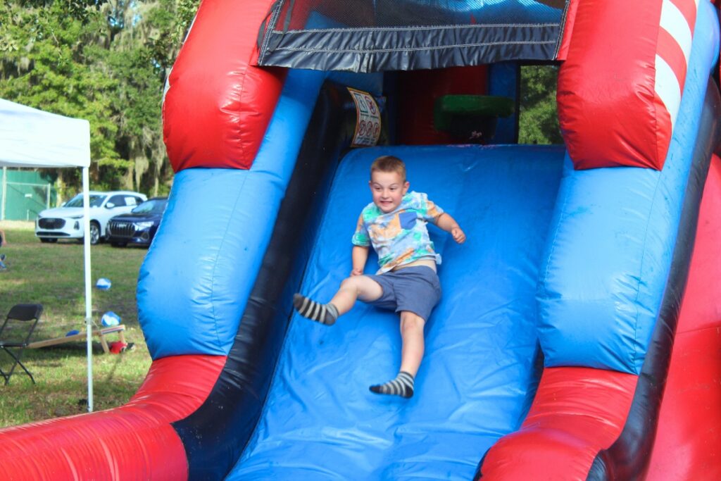 A child slides down an inflatable slide at Thursday's event. Photo by Nick Anschutlz