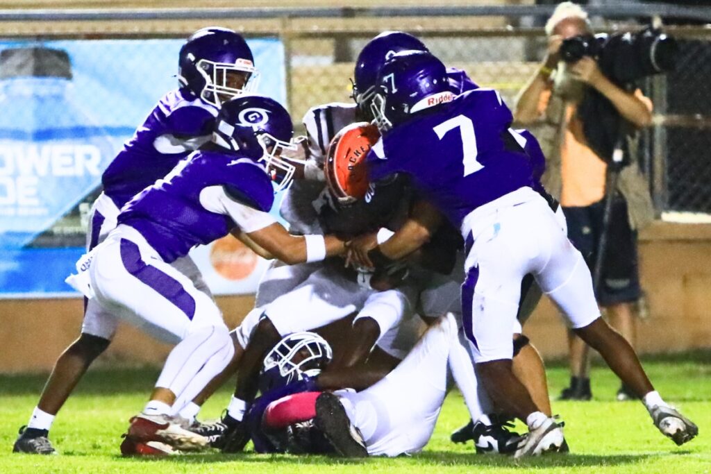 A group of Gainesville defenders bring down a Leesburg receiver. Photo by C.J. Gish