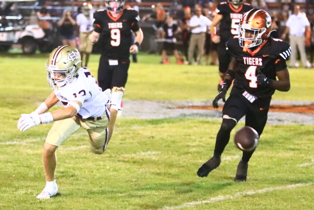 A second-half pass goes beyond the reach of Oak Hall's Bradley Wise (13) against Trenton. Photo by C.J. Gish