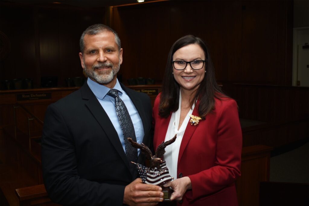 Attorney General Ashley Moody presents GPD's Detective Sergeant Nick Ferrara with an award as nominee for 2022 Officer of the Year. 