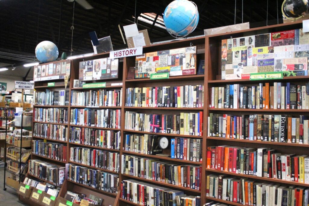 Books stacked on shelves ahead of the Friends of the Library fall book sale.