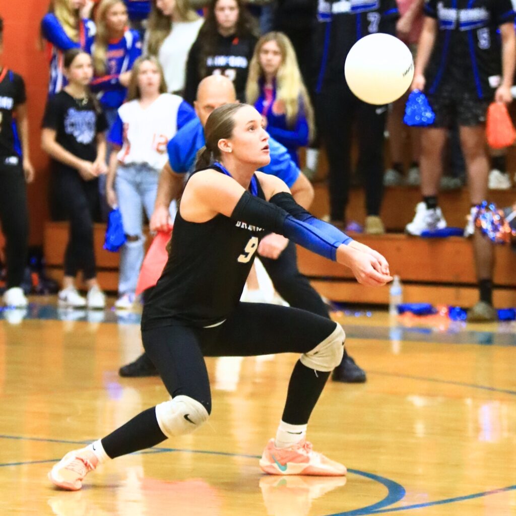 Branford's Emma Alcorn (9) with a dig against Union County. Photo by C.J. Gish