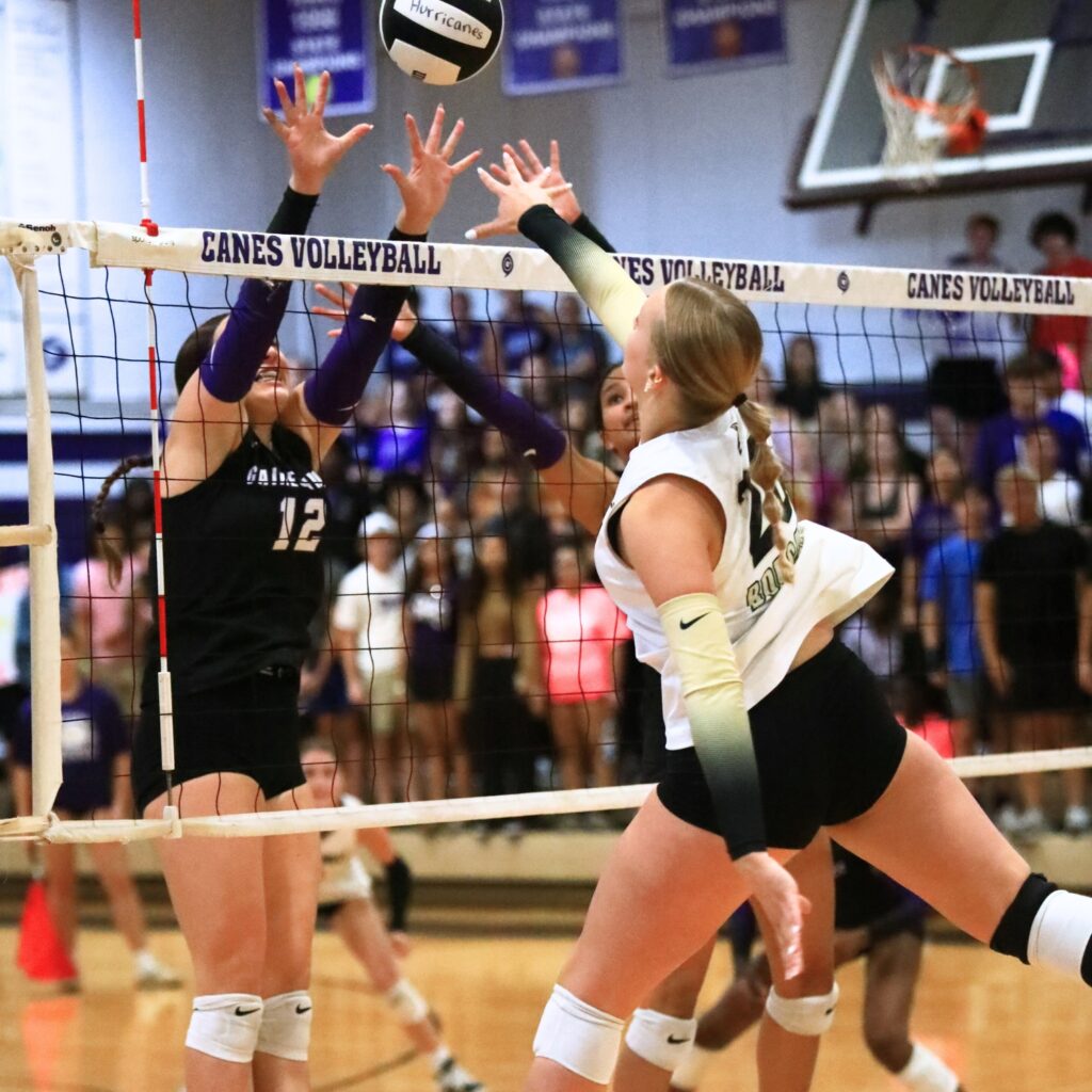 Buchholz's Aubrey Waters (20) battles at the net with Gainesville's Sloane Childers (12) and Jacey Carter-Mitchell (1). Photo by C.J. Gish