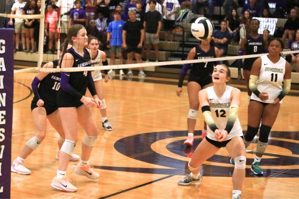Buchholz's Taylor Sembower (12) with a dig against Gainesville. Photo by C.J. Gish