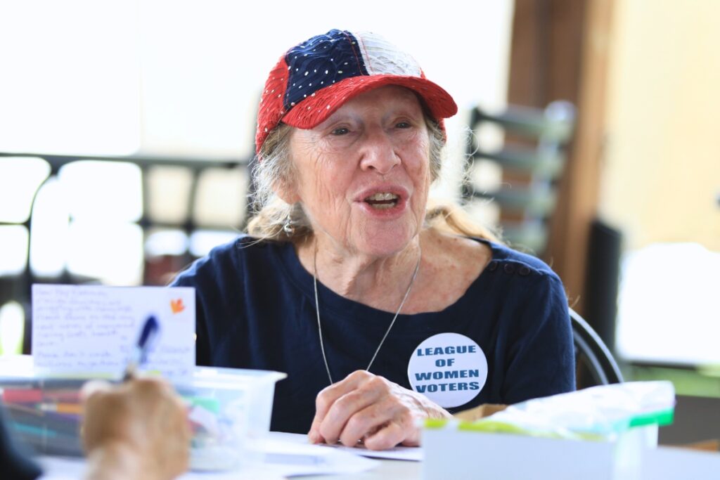 Donna Waller speaks with League of Women Voters of Alachua County members during a card signing event on Saturday. Photo by Seth Johnson