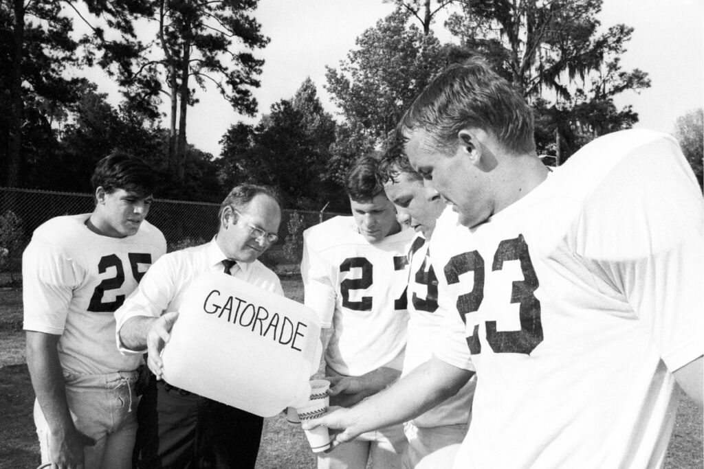 Dr. Robert Cade pouring Gatorade into cups for University of Florida football players in 1968. Courtesy of FleishmanHillard