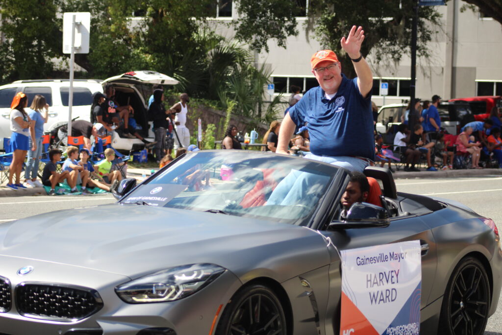 Gainesville Mayor Harvey Ward waves during the UF Homecoming Parade
