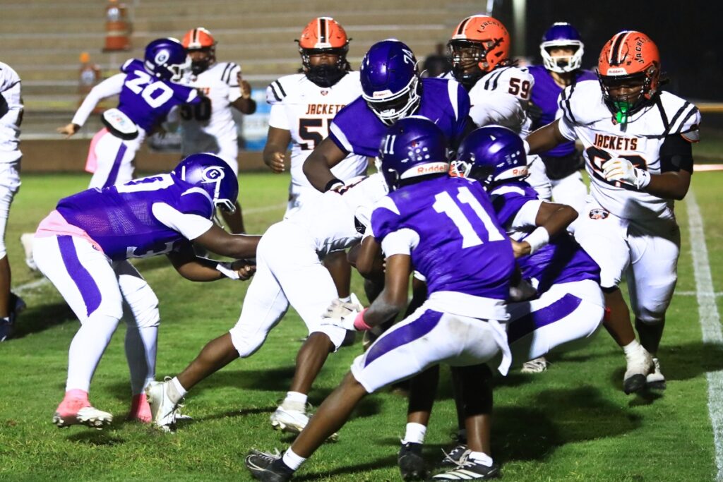Gainesville defenders bring down a Leesburg running back. Photo by C.J. Gish