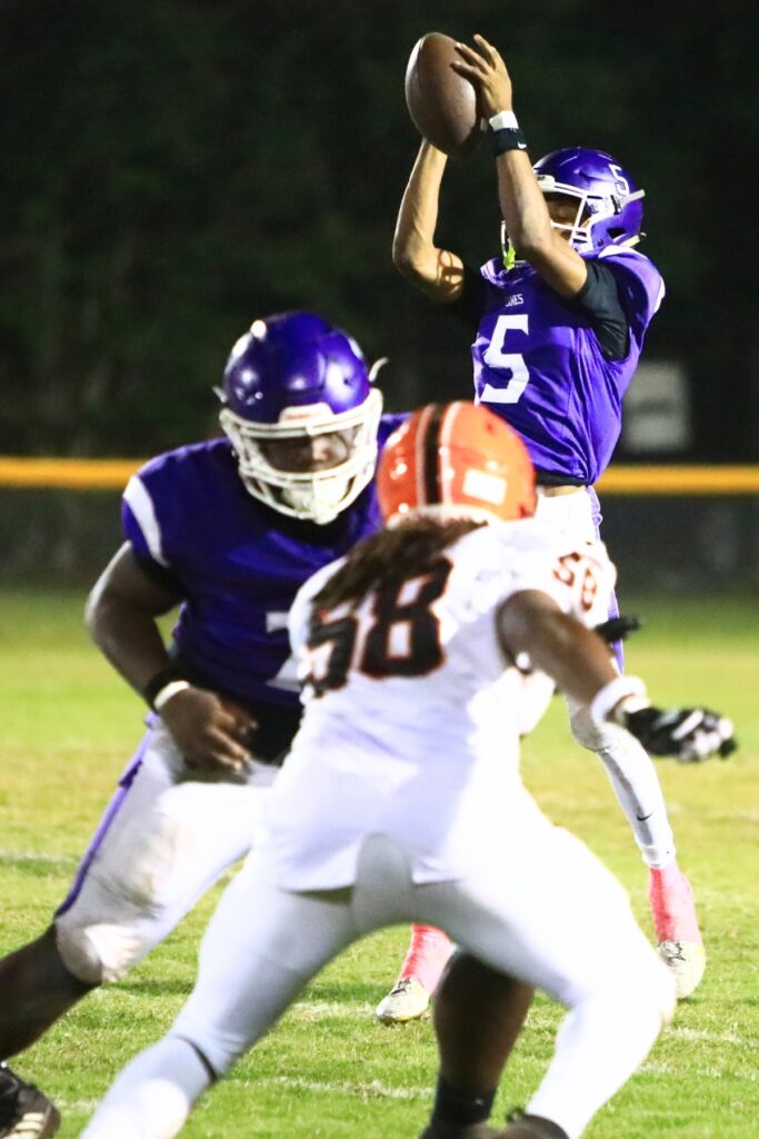 Gainesville quarterback Jaishawn Sanford pulls down one of many high snaps during a game against Leesburg. Photo by C.J. Gish