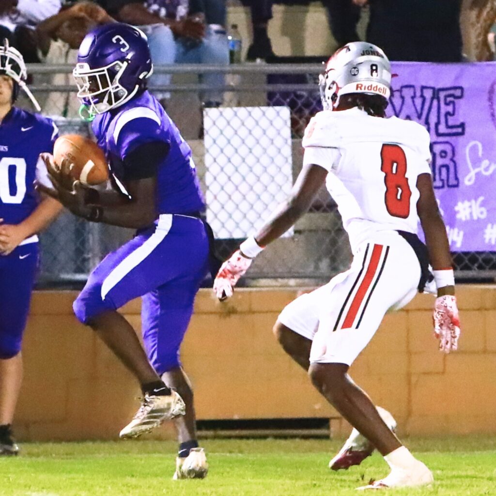 Gainesville's Aric Welch (3) hauls in a deep pass in the second quarter against Williston's Maverick Jones (8). Photo by C.J. Gish