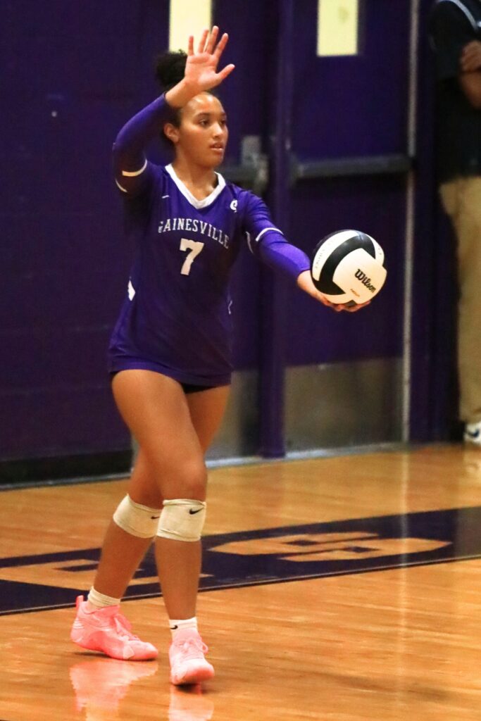 Gainesville's Jordyn Barnard (7) with a serve against Belleview in the Class 5A-District 5 semifinals. Photo by C.J. Gish