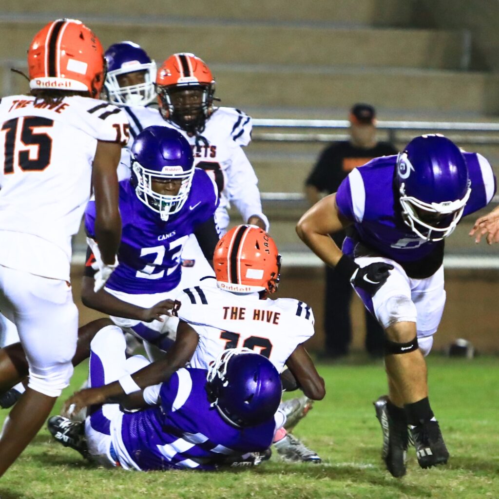 Gainesville's Joshua McClellan (12) brings down a Leesburg runner in the first half. Photo by C.J. Gish