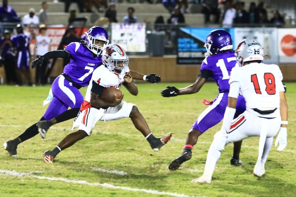 Gainesville's Nehemiah Washington (7) and Carone Davis (17) zero in on Williston's Kameryn Manneh (4). Photo by C.J. Gish