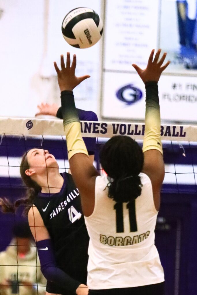 Gainesville's Rowan Kage (4) goes for a hit against Buchholz's Demmi Strappy (11). Photo by C.J. Gish
