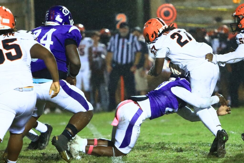 Gainesville's Samuel Warren (20) brings down a Leesburg runner in the first half. Photo by C.J. Gish 1 (1)