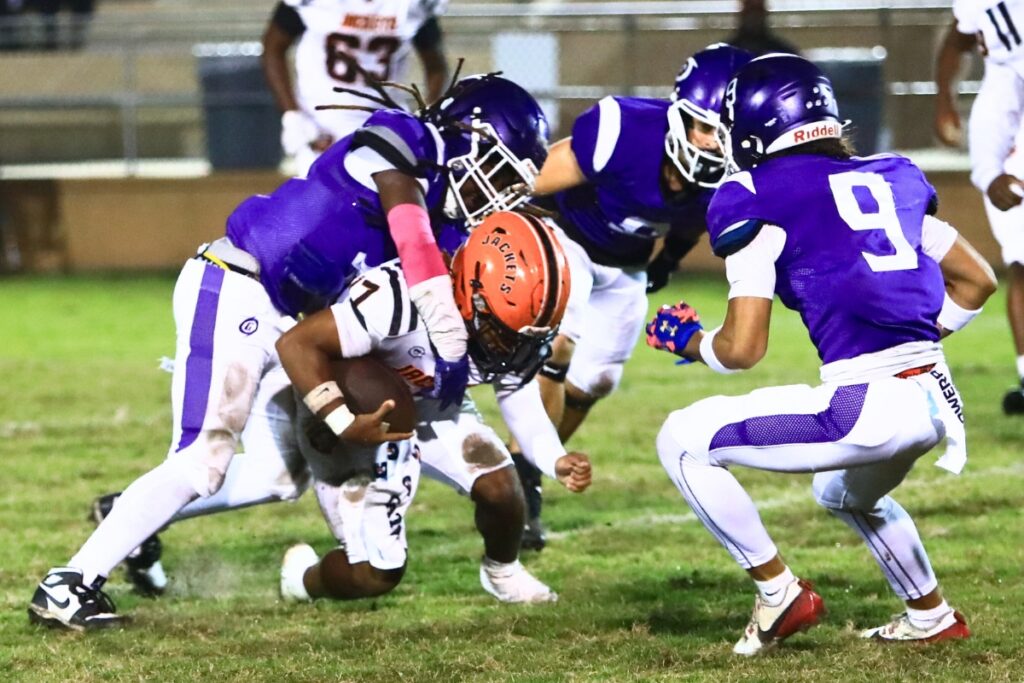 Gainesville's Zaire Francis (4) with a first-half tackle against Leesburg. Photo by C.J. Gish
