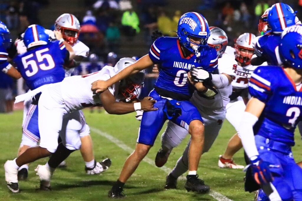 Keystone Heights' Hunter Crumpton (0) with a quarterback keeper against Santa Fe. Photo by C.J. Gish