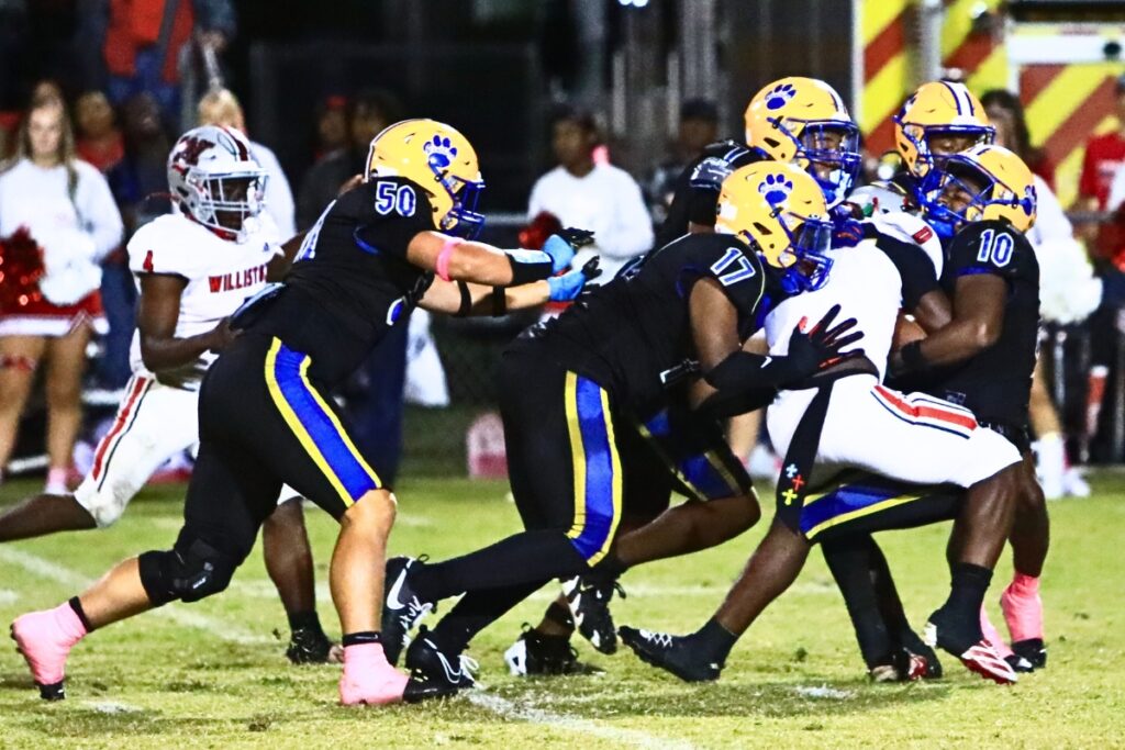 Newberry defenders bring down Williston's Omarian Walker (0). Photo by C.J. Gish