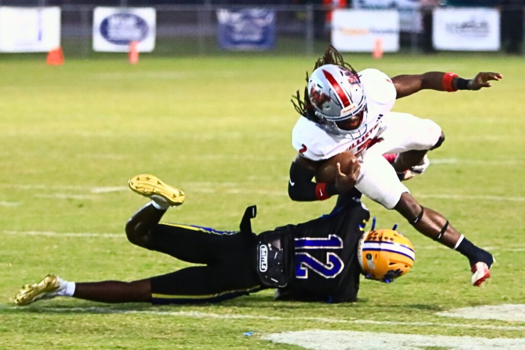 Newberry's Demetrius Debose (12) tackles Williston's J'Dyen Manneh (2). Photo by C.J. Gish