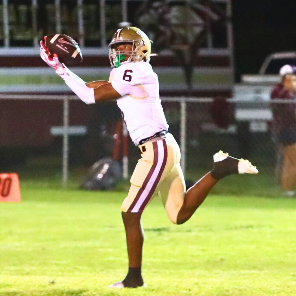 Oak Hall's Darius Medley (6) hauls in a first-quarter pass and runs for a touchdown against Trenton. Photo by C.J. Gish