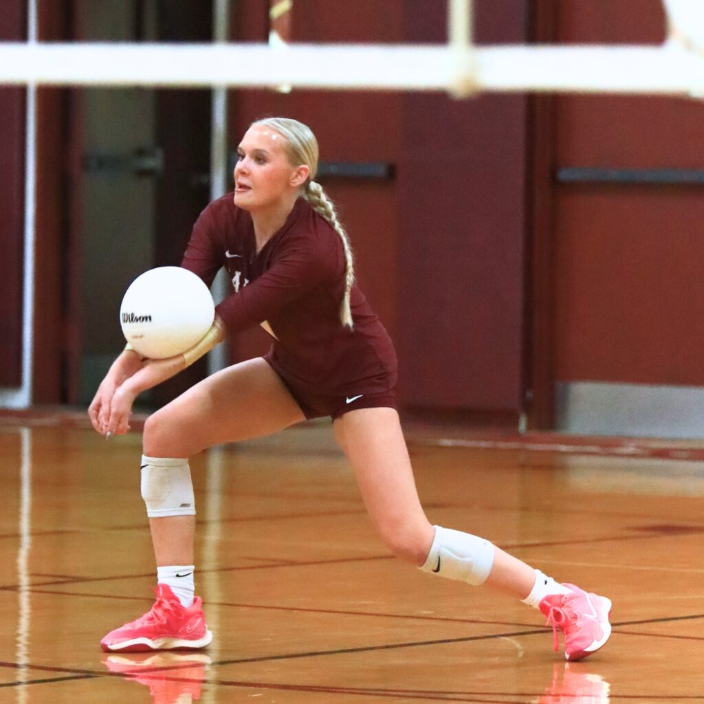 Oak Hall's Josie Pickens (11) with a dig against Saint Francis Catholic. Photo by C.J. Gish