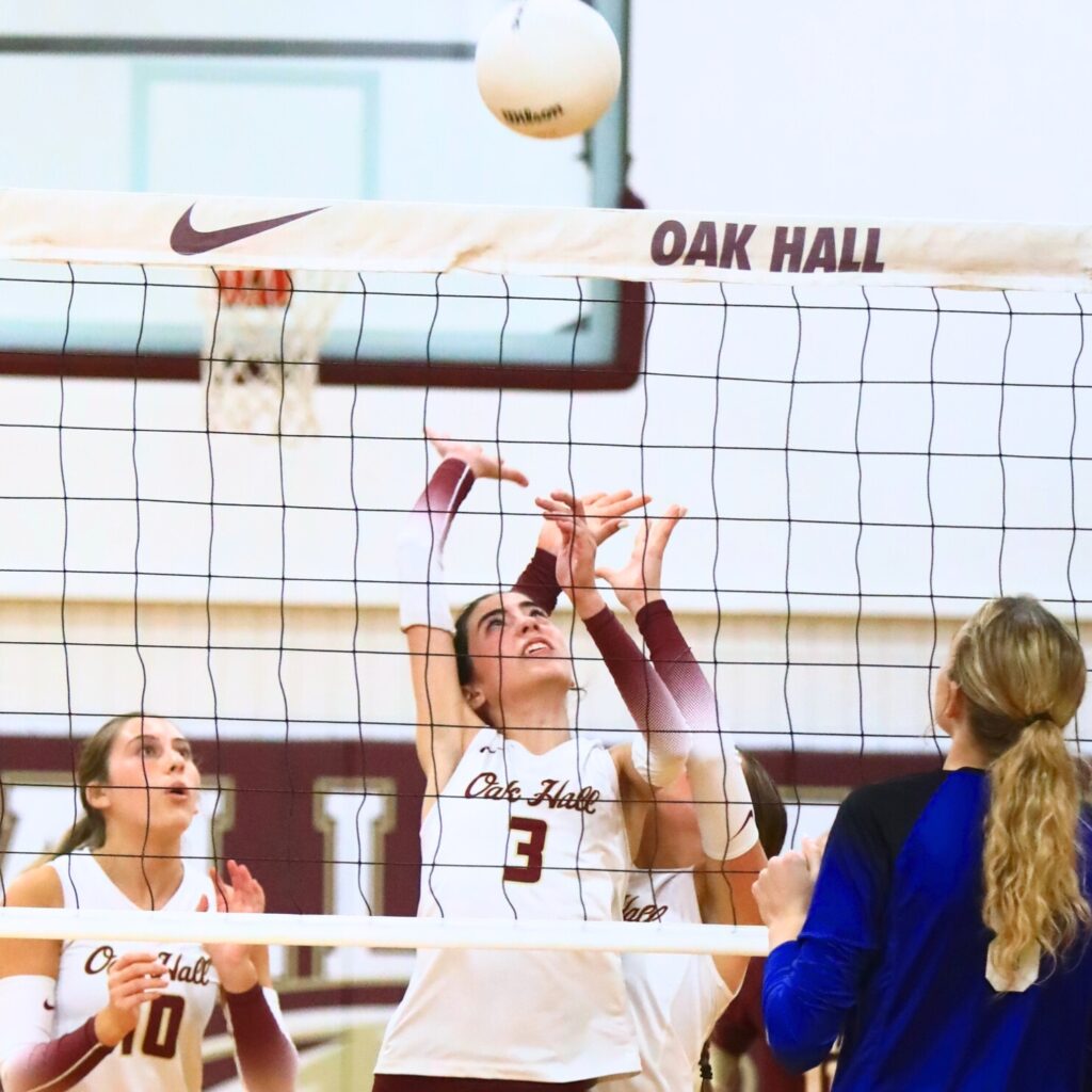 Oak Hall's Kaitlin Allen (3) and Kendylle Bishop (14) both go for the ball against Saint Francis Catholic. Photo by C.J. Gish