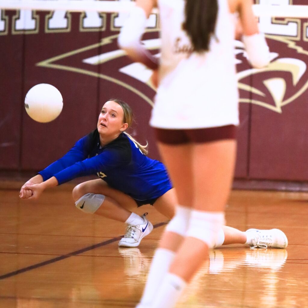 Saint Francis Catholic's Audrey Whisler (23) with a dig against Oak Hall. Photo by C.J. Gish