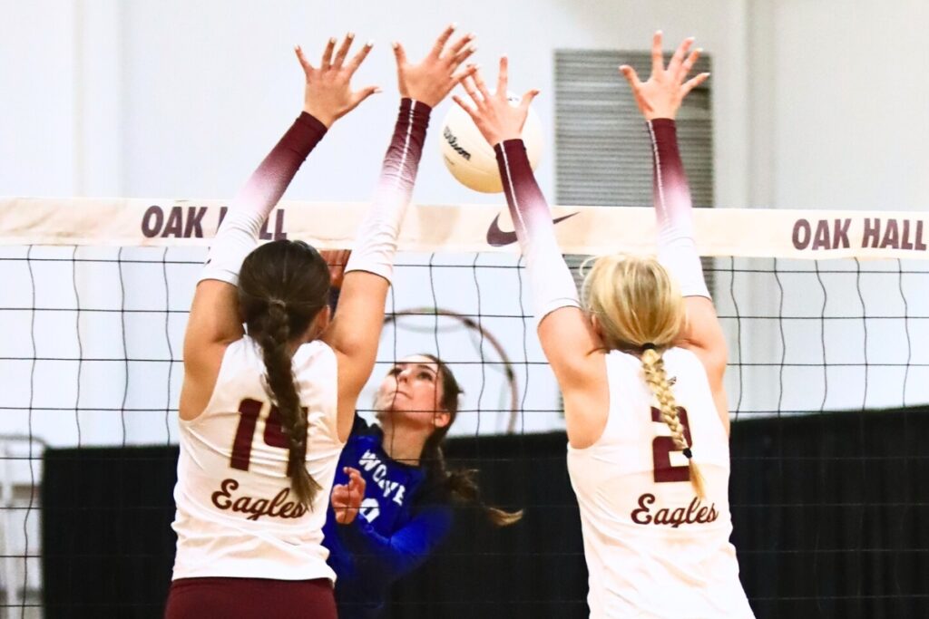 Saint Francis Catholic's Gianna Morali (9) with a hit against Oak Hall's Kendylle Bishop (14) and Lizzie Cannon (2). Photo by C.J Gish