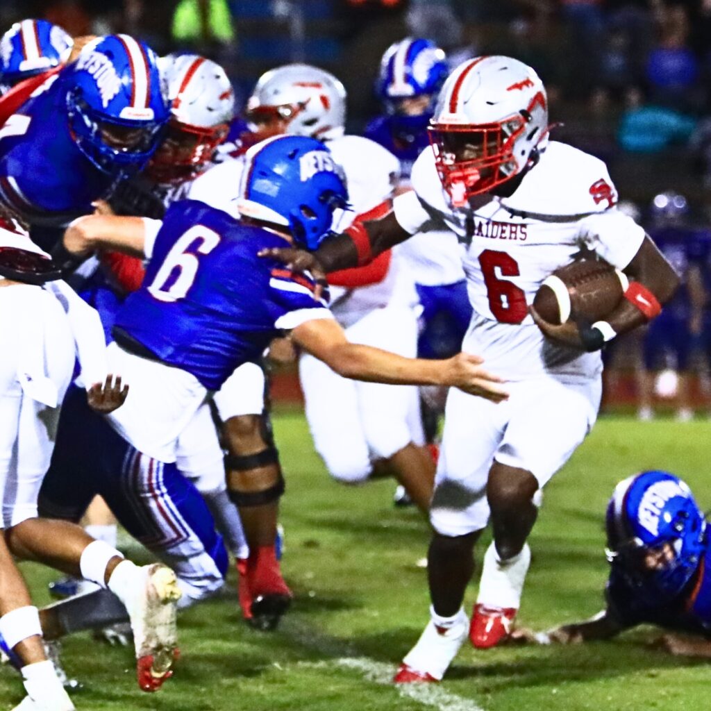 Santa Fe's Dantre Little (6) gets past Keystone Heights' Micah Screen (6). Photo by C.J. Gish