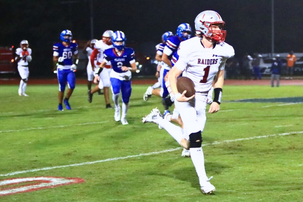 Santa Fe's Tyler Gentry (1) outraces Keystone Heights defenders for a 65-yard touchdown. Photo by C.J. Gish