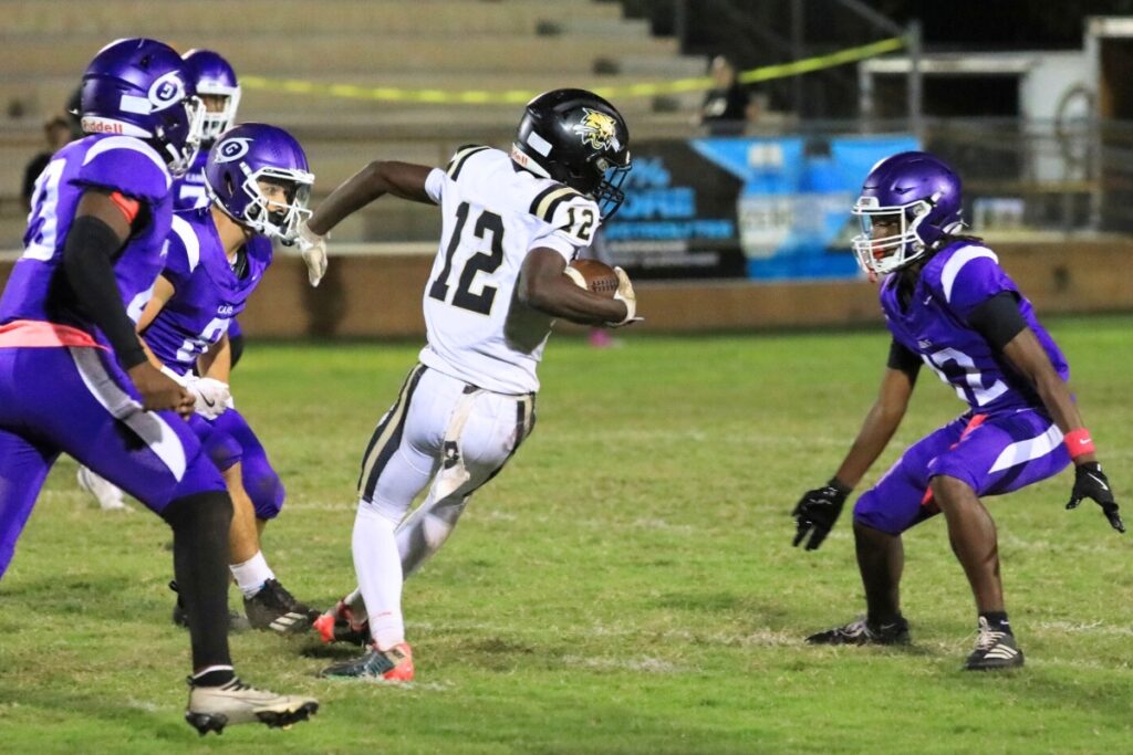 Spinning from a catch, Buchholz's Marquel Brooks finds himself surrounded by Gainesville defenders. Photo by Seth Johnson