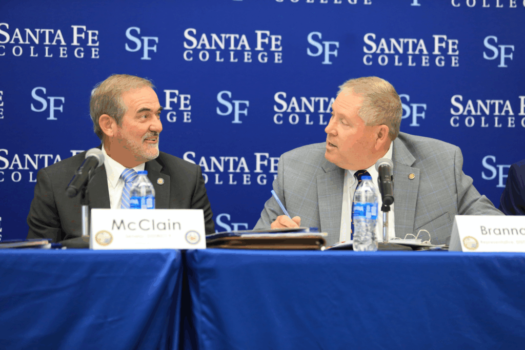 State Sen. Stan McClain (left) speaks with state Rep. Chuck Brannan at the 2026 Alachua County Legislative Delegation meeting. Photo by Seth Johnson