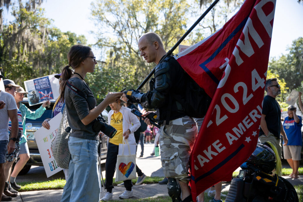 The only counter-protester, who only wished to be named as _Ted_, can be seen weilding a Trump flag at the No Kings Gainesville protest